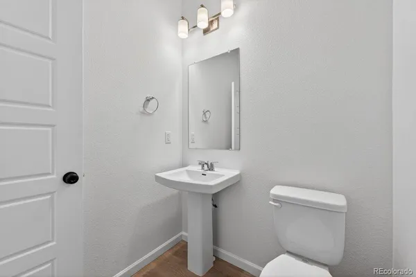 a bathroom with a sink mirror and toilet