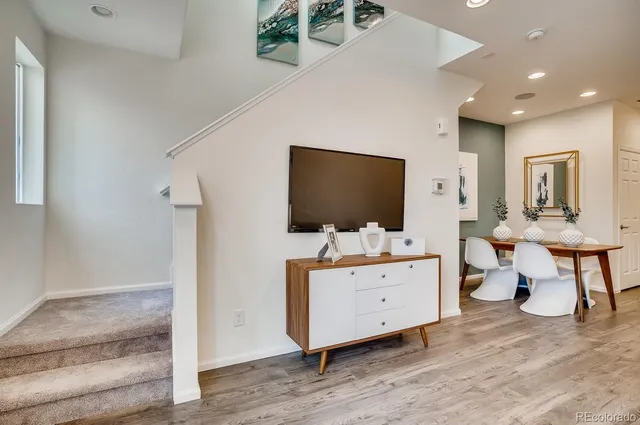 a bedroom with a large bed and painting on the wall