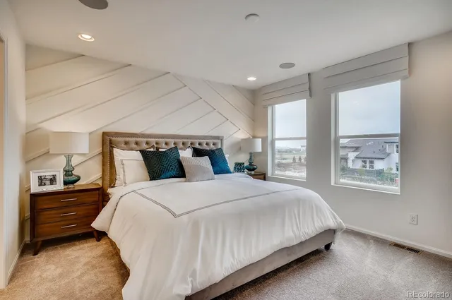 a bedroom with a large bed and a chandelier