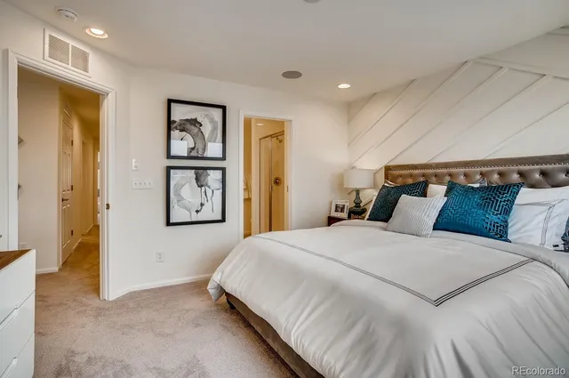 a bed sitting in a bedroom next to a window