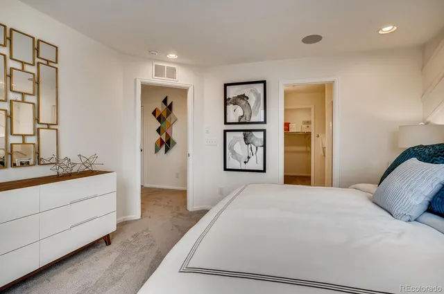 a en suite bathroom with a granite countertop sink and a mirror