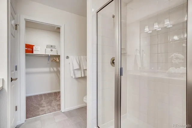 a kitchen with stainless steel appliances kitchen island granite countertop a refrigerator and a stove top oven