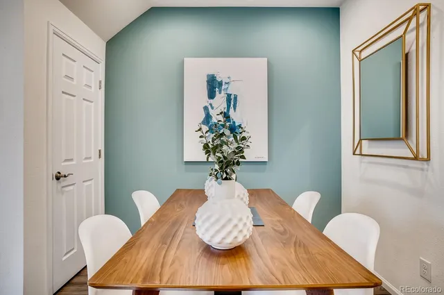 a kitchen with a sink stove cabinets and wooden floor