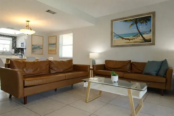 a living room with furniture and a painting