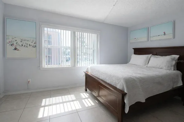 a bedroom with a bed and a television in it