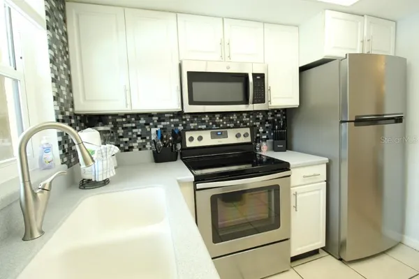 a kitchen with a refrigerator and a sink