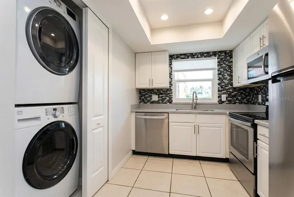 a kitchen with a washer and dryer in it