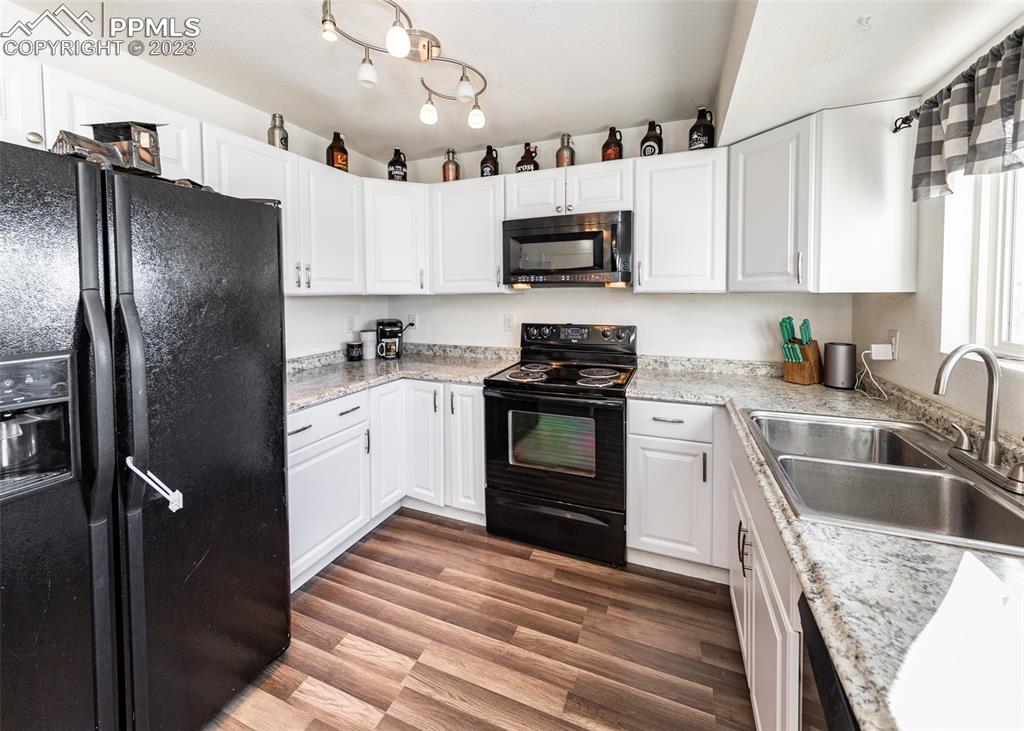 9765 Wineglass Road Fountain, CO 80817 - Photo 11 of 37 a kitchen with stainless steel appliances granite countertop a refrigerator sink and stove