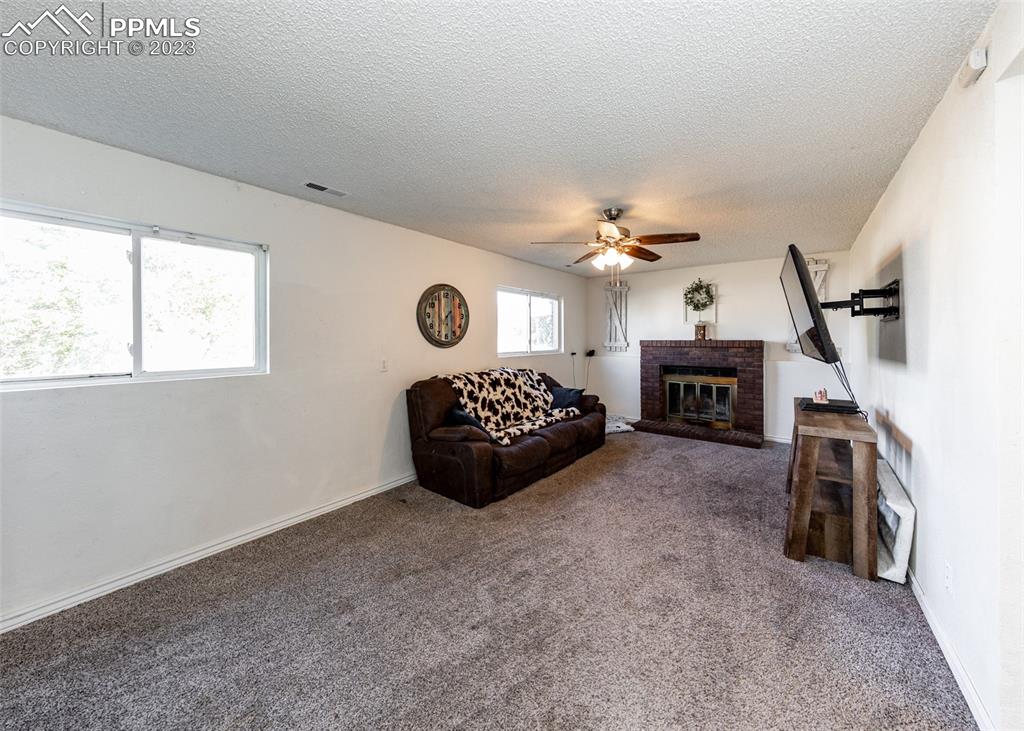9765 Wineglass Road Fountain, CO 80817 - Photo 14 of 37 a spacious bedroom with a bed and a fireplace