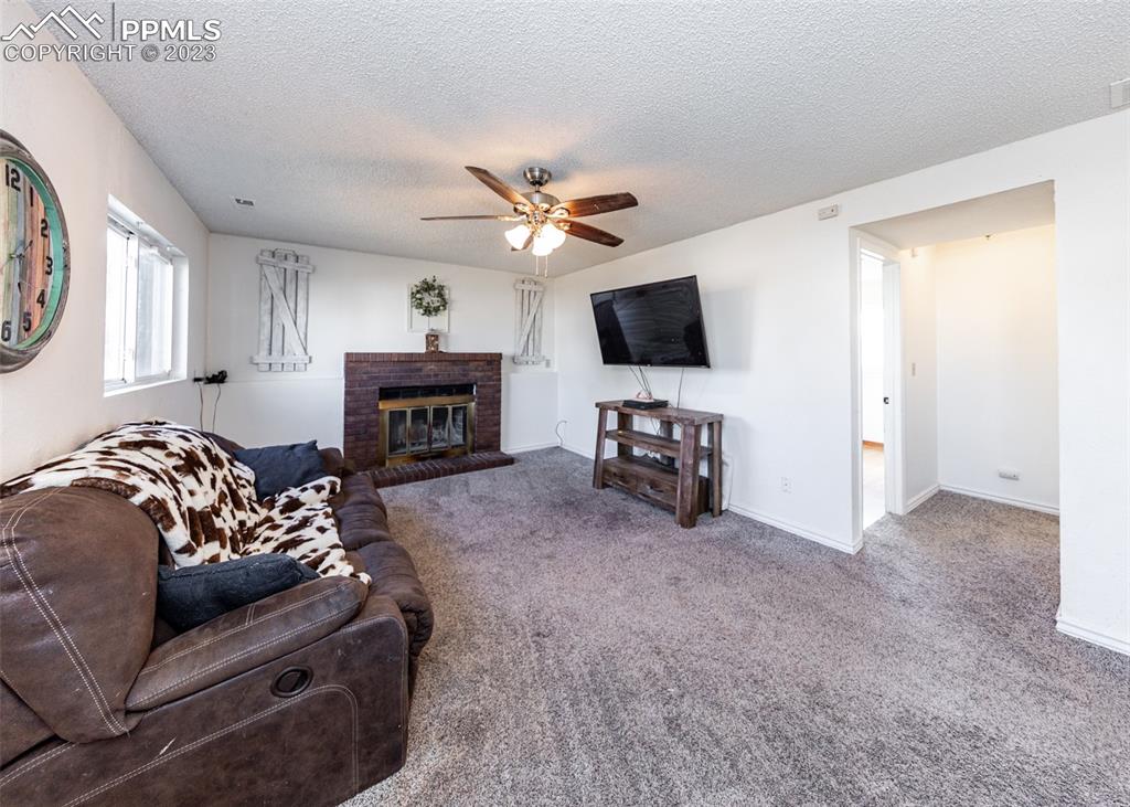 9765 Wineglass Road Fountain, CO 80817 - Photo 16 of 37 a living room with furniture and a flat screen tv