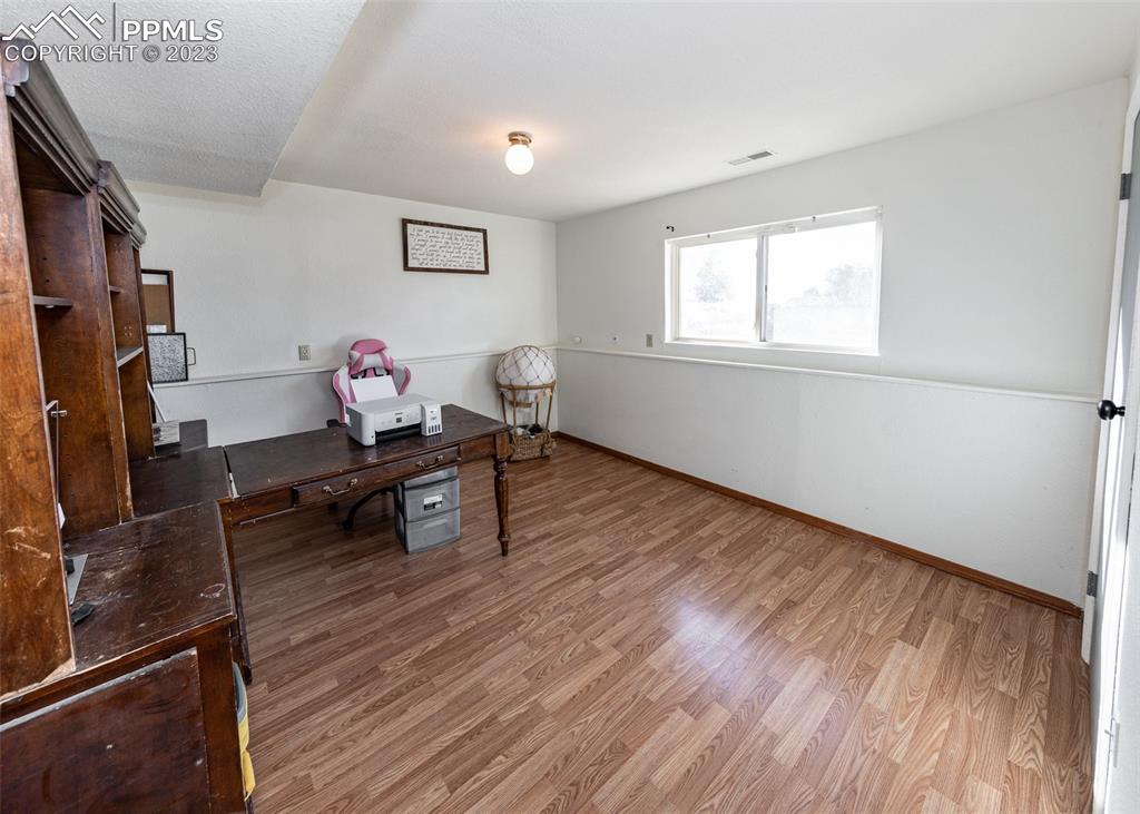 9765 Wineglass Road Fountain, CO 80817 - Photo 18 of 37 a living room with wooden floor and a window