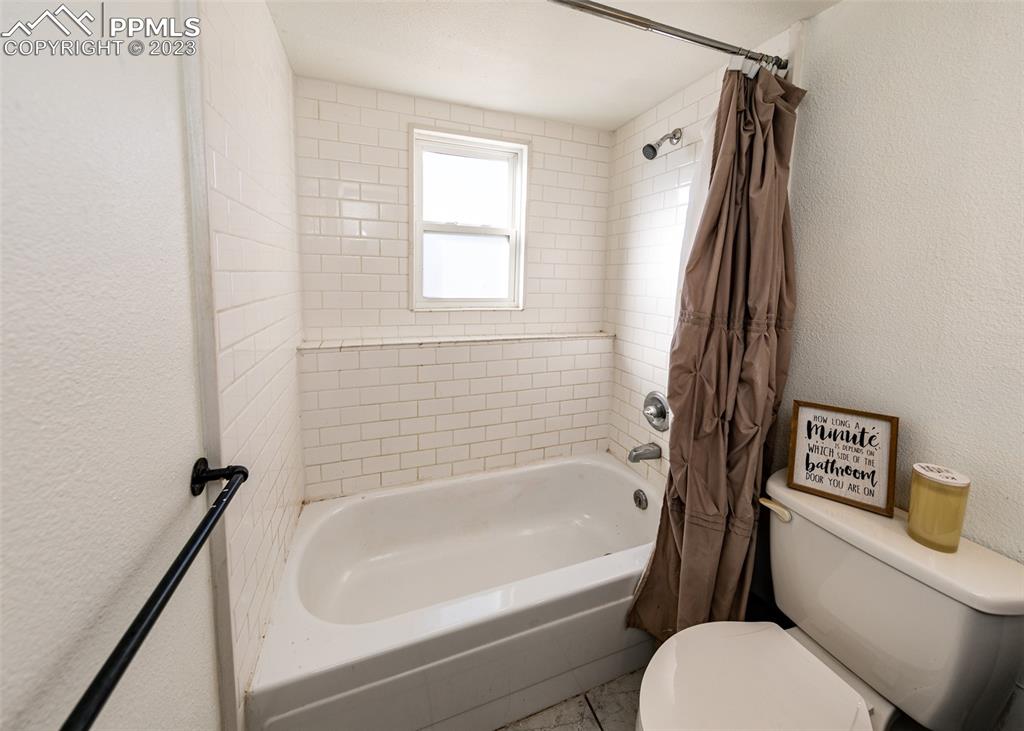 9765 Wineglass Road Fountain, CO 80817 - Photo 20 of 37 a bathroom with a toilet and a bathtub