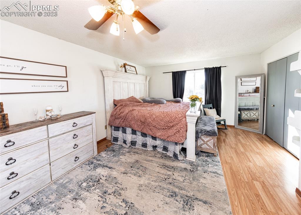 9765 Wineglass Road Fountain, CO 80817 - Photo 28 of 37 a spacious bedroom with a bed and a dresser