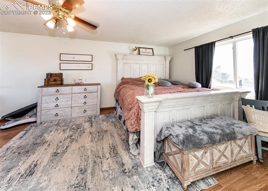 9765 Wineglass Road Fountain, CO 80817 - Photo 29 of 37 a bedroom with a bed and a chandelier