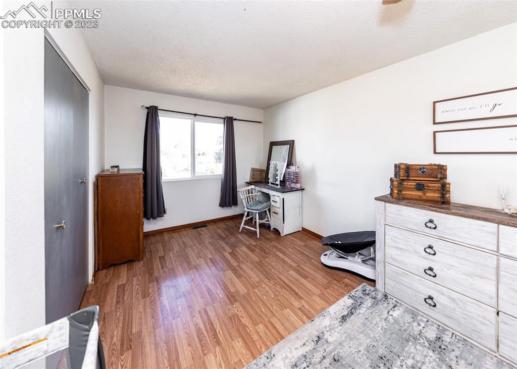 9765 Wineglass Road Fountain, CO 80817 - Photo 30 of 37 a room with furniture and a wooden floor