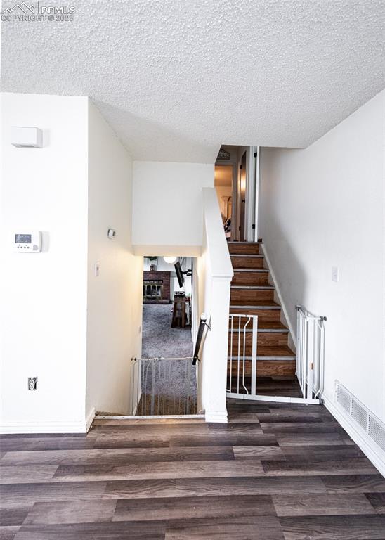 9765 Wineglass Road Fountain, CO 80817 - Photo 3 of 37 a view of a livingroom with wooden floor and stairs