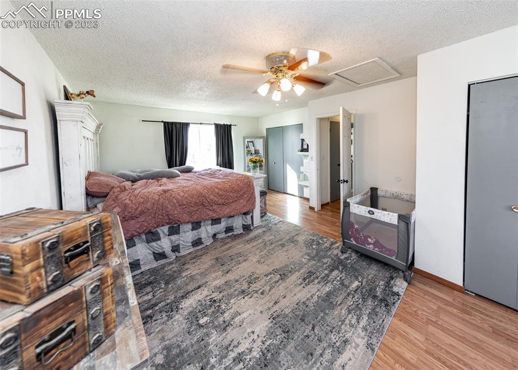 9765 Wineglass Road Fountain, CO 80817 - Photo 31 of 37 a bedroom with bed and wooden floor