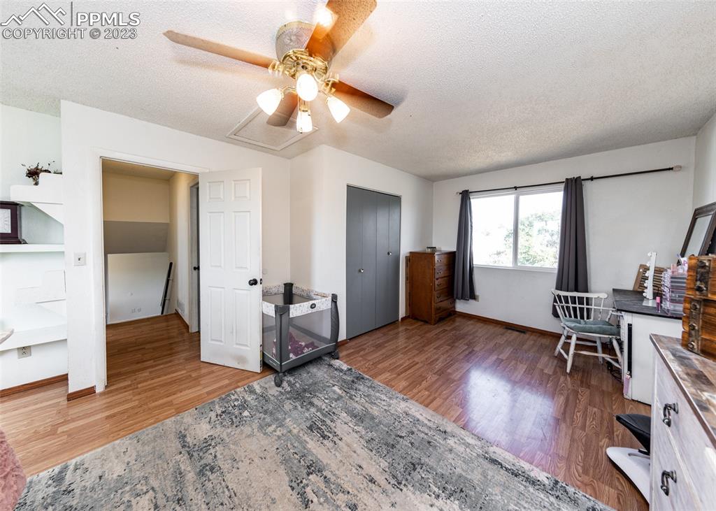 9765 Wineglass Road Fountain, CO 80817 - Photo 33 of 37 a living room with furniture and a wooden floor