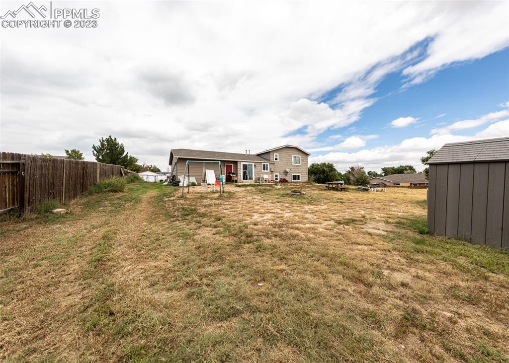 9765 Wineglass Road Fountain, CO 80817 - Photo 34 of 37 a view of a house with a yard
