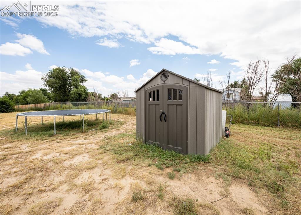 9765 Wineglass Road Fountain, CO 80817 - Photo 35 of 37 a view of a wooden house with a yard