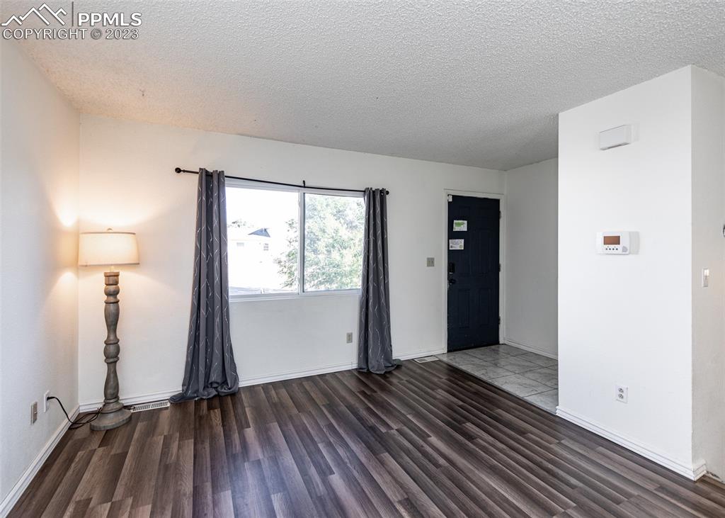9765 Wineglass Road Fountain, CO 80817 - Photo 4 of 37 wooden floor in an empty room with a window