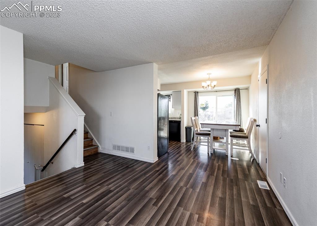 9765 Wineglass Road Fountain, CO 80817 - Photo 5 of 37 a view of a livingroom with wooden floor and staircase