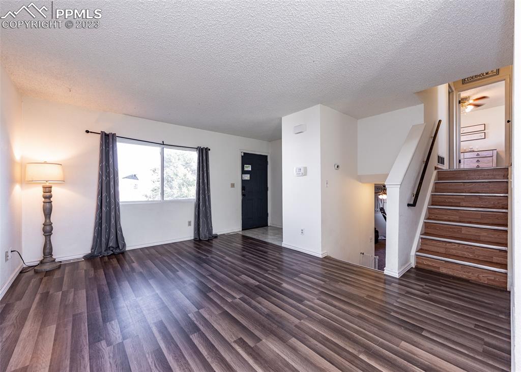 9765 Wineglass Road Fountain, CO 80817 - Photo 6 of 37 a view of empty room with wooden floor and fan