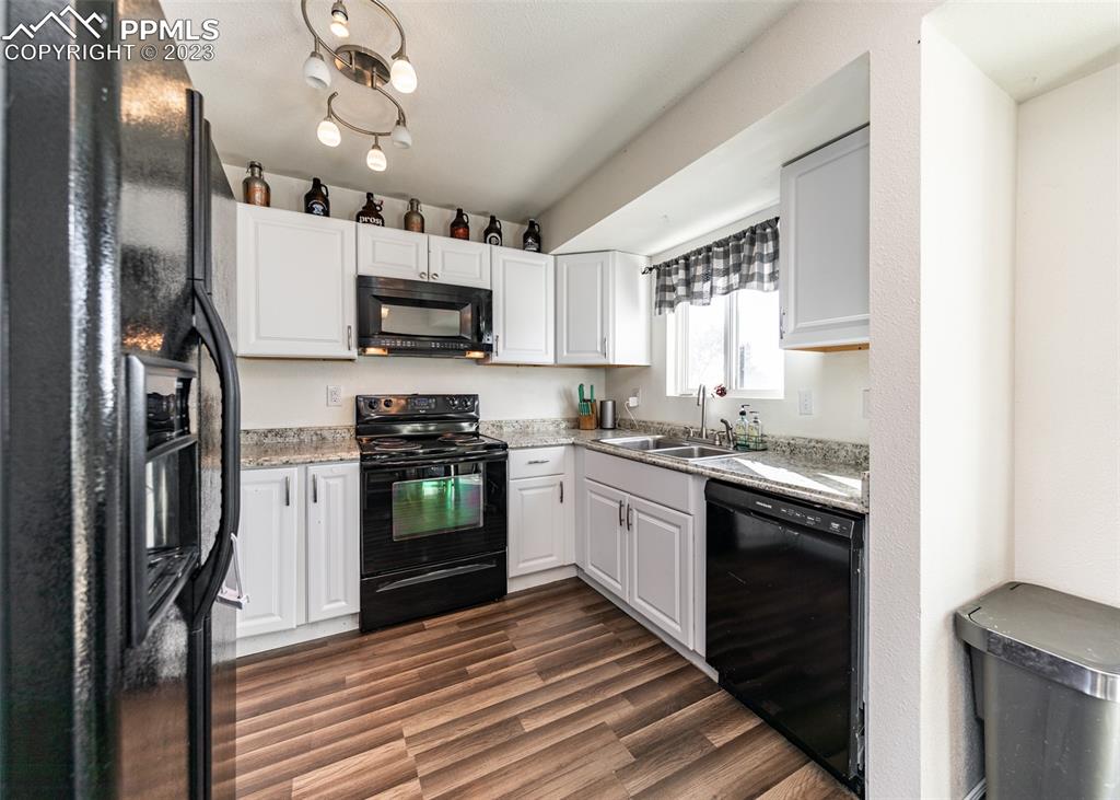 9765 Wineglass Road Fountain, CO 80817 - Photo 10 of 37 a kitchen with stainless steel appliances granite countertop a stove top oven a sink and a refrigerator