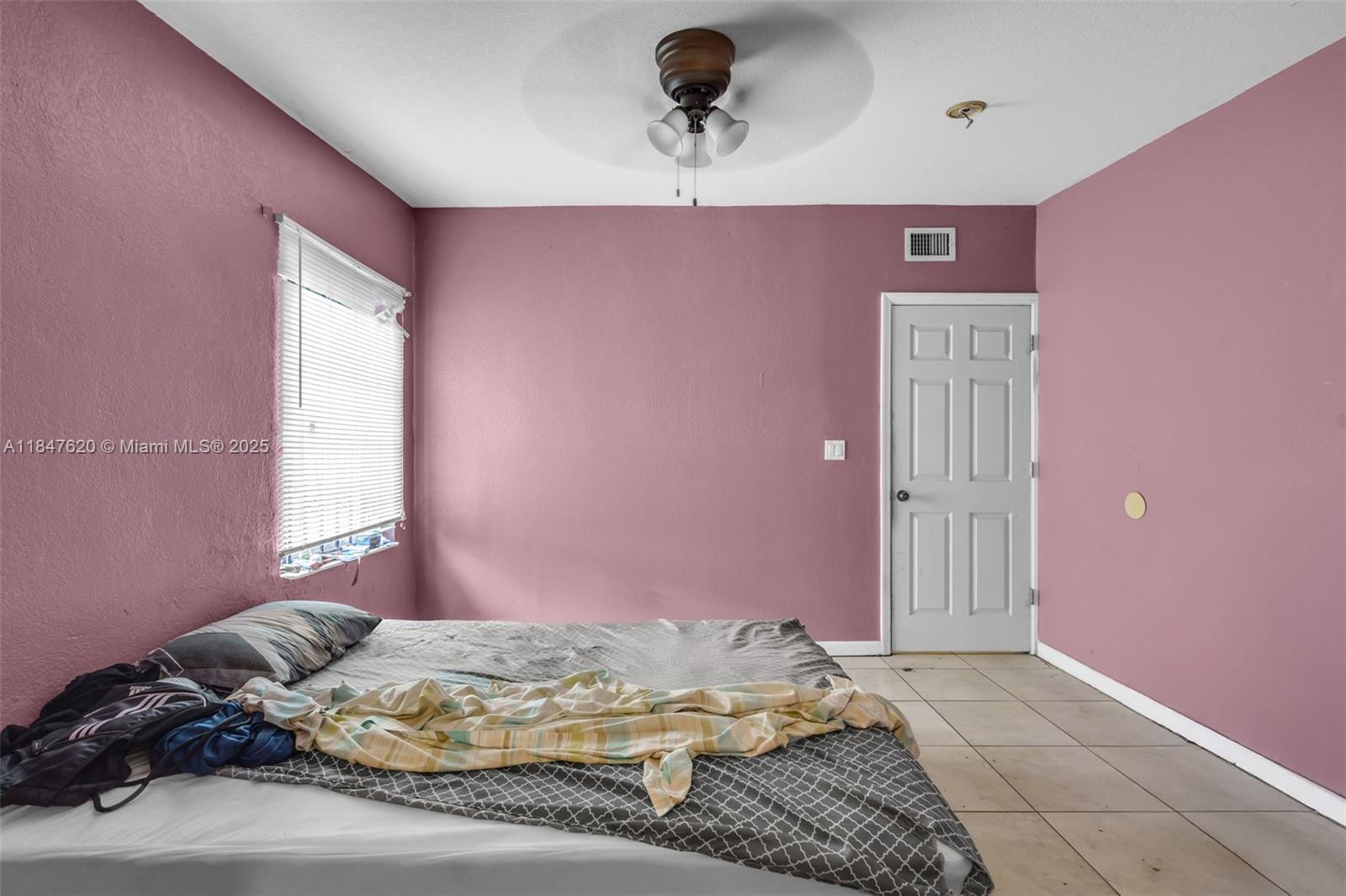 1900 Service Road Opa-Locka, FL 33054 - Photo 15 of 24 a bedroom with a bed and a window