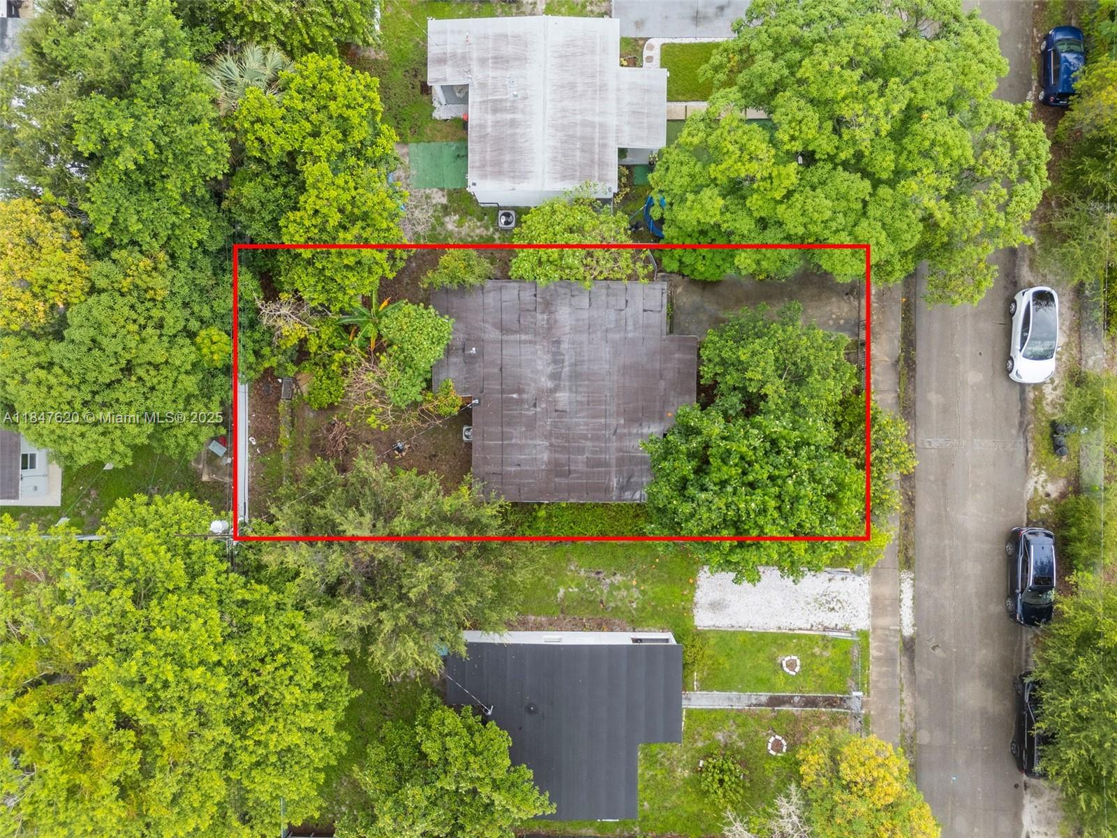 1900 Service Road Opa-Locka, FL 33054 - Photo 21 of 24 an aerial view of a house with a yard and large trees