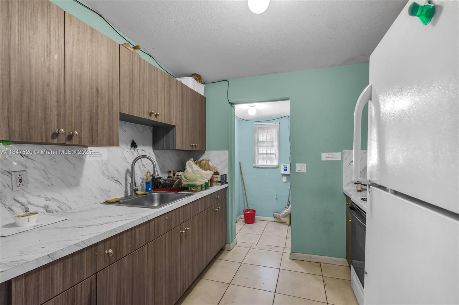 1900 Service Road Opa-Locka, FL 33054 - Photo 6 of 24 a kitchen with a sink and cabinets