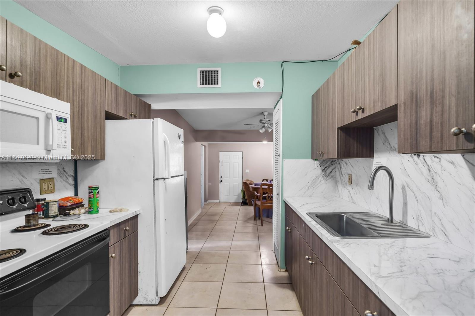 1900 Service Road Opa-Locka, FL 33054 - Photo 7 of 24 a kitchen with stainless steel appliances granite countertop a refrigerator stove and sink