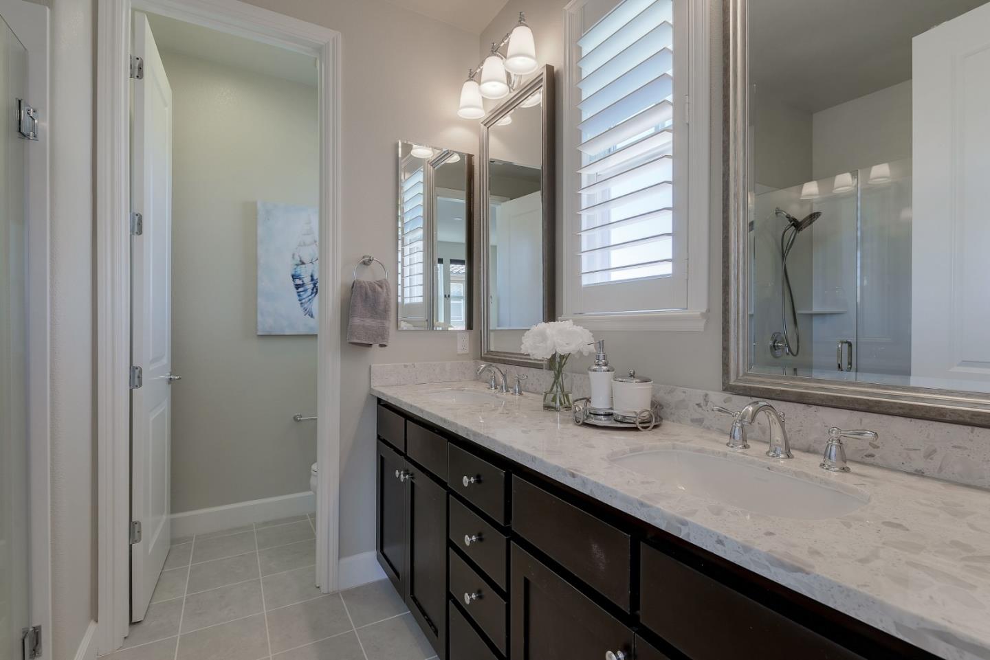 2881 Predio Terrace Fremont, CA 94539 - Photo 13 of 16 a bathroom with a granite countertop sink and a mirror