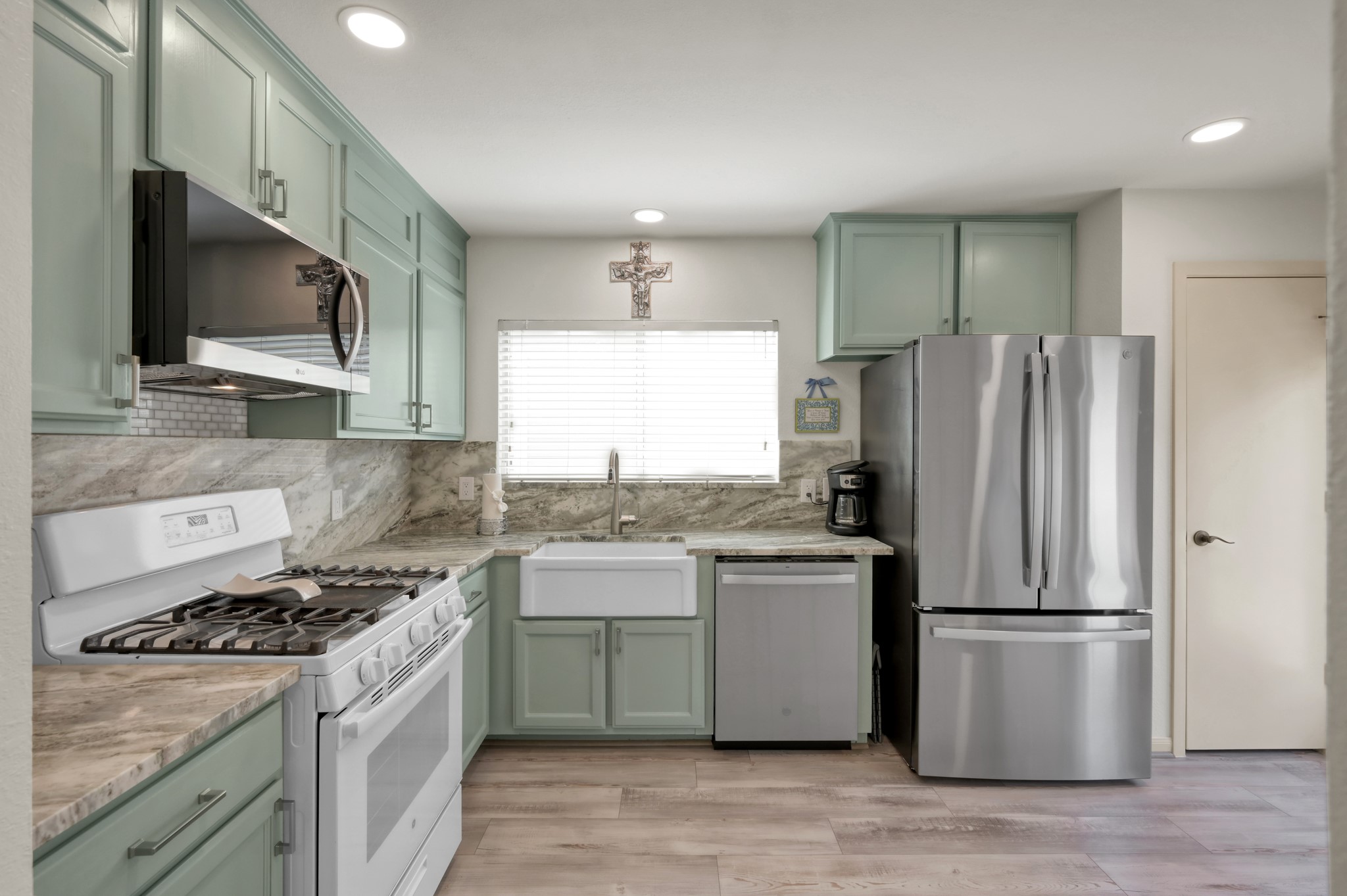 21815 Mossy Field Lane Spring, TX 77388 - Photo 11 of 39 Farmhouse sink blends charm and functionality with updated garbage disposal, new dishwasher and microwave.