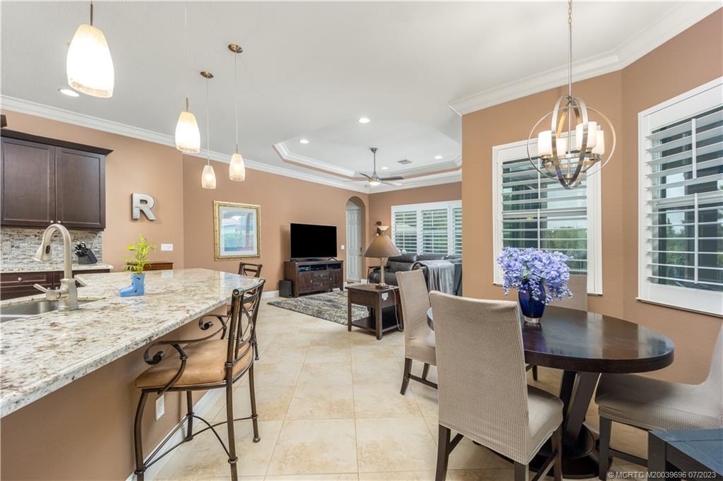 6863 Southeast Pierre Circle Stuart, FL 34997 - Photo 13 of 39 a view of a dining room with furniture window and outside view