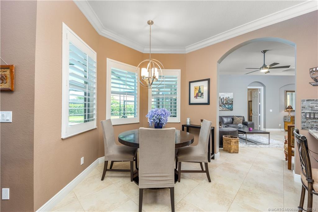 6863 Southeast Pierre Circle Stuart, FL 34997 - Photo 14 of 39 a view of a dining room with furniture window and outside view
