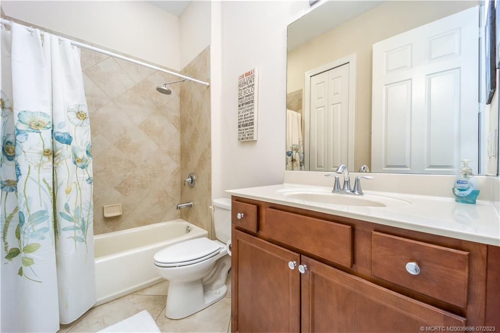 6863 Southeast Pierre Circle Stuart, FL 34997 - Photo 26 of 39 a bathroom with a sink toilet a shower and a bathtub