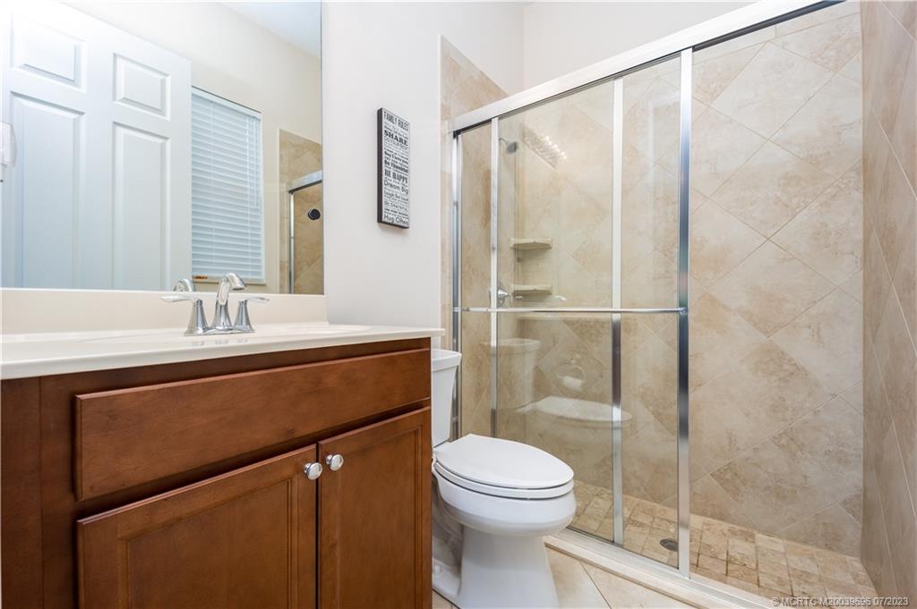 6863 Southeast Pierre Circle Stuart, FL 34997 - Photo 30 of 39 a bathroom with a sink a toilet and shower