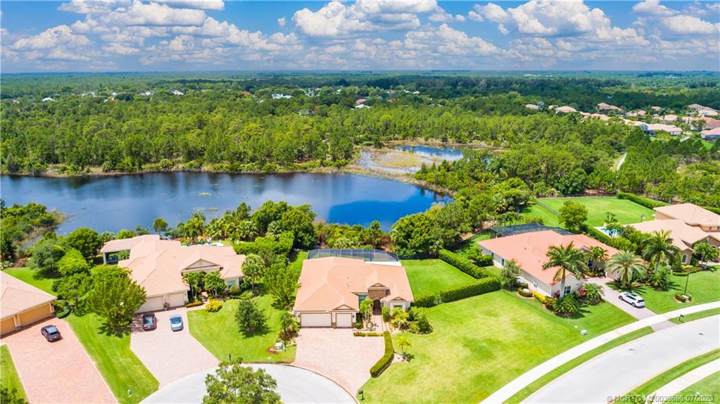 6863 Southeast Pierre Circle Stuart, FL 34997 - Photo 3 of 39 an aerial view of a house with a lake view