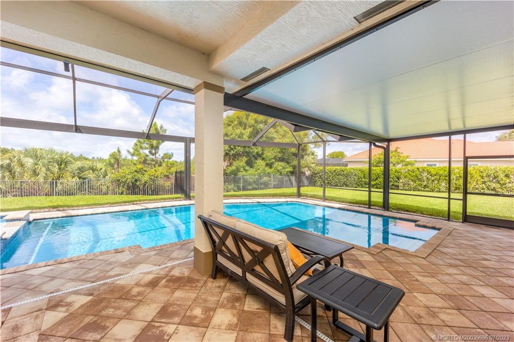 6863 Southeast Pierre Circle Stuart, FL 34997 - Photo 33 of 39 a view of swimming pool with outdoor seating