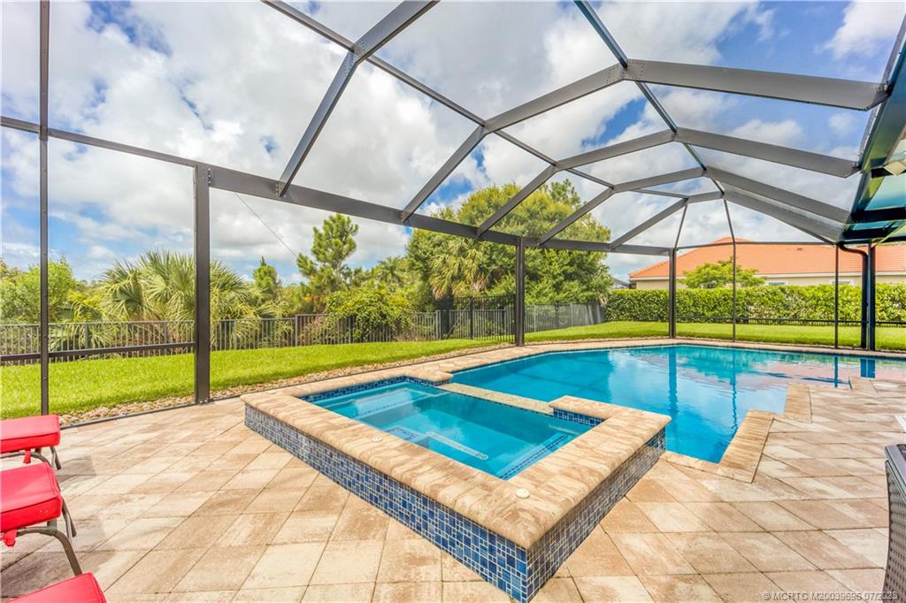 6863 Southeast Pierre Circle Stuart, FL 34997 - Photo 36 of 39 a view of swimming pool with a bench in patio