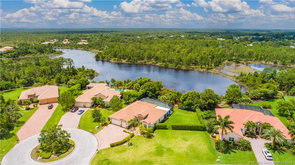 6863 Southeast Pierre Circle Stuart, FL 34997 - Photo 4 of 39 a view of a lake with a building in the background