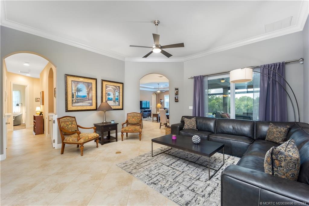 6863 Southeast Pierre Circle Stuart, FL 34997 - Photo 10 of 39 a living room with furniture and a large window