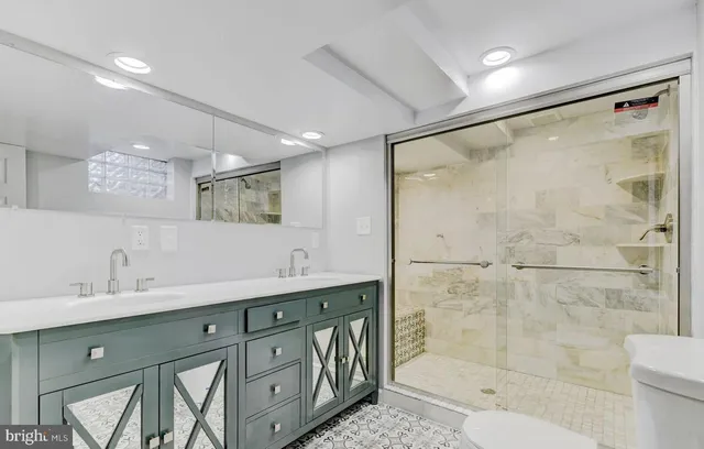 a spacious bathroom with a shower sink mirror and toilet