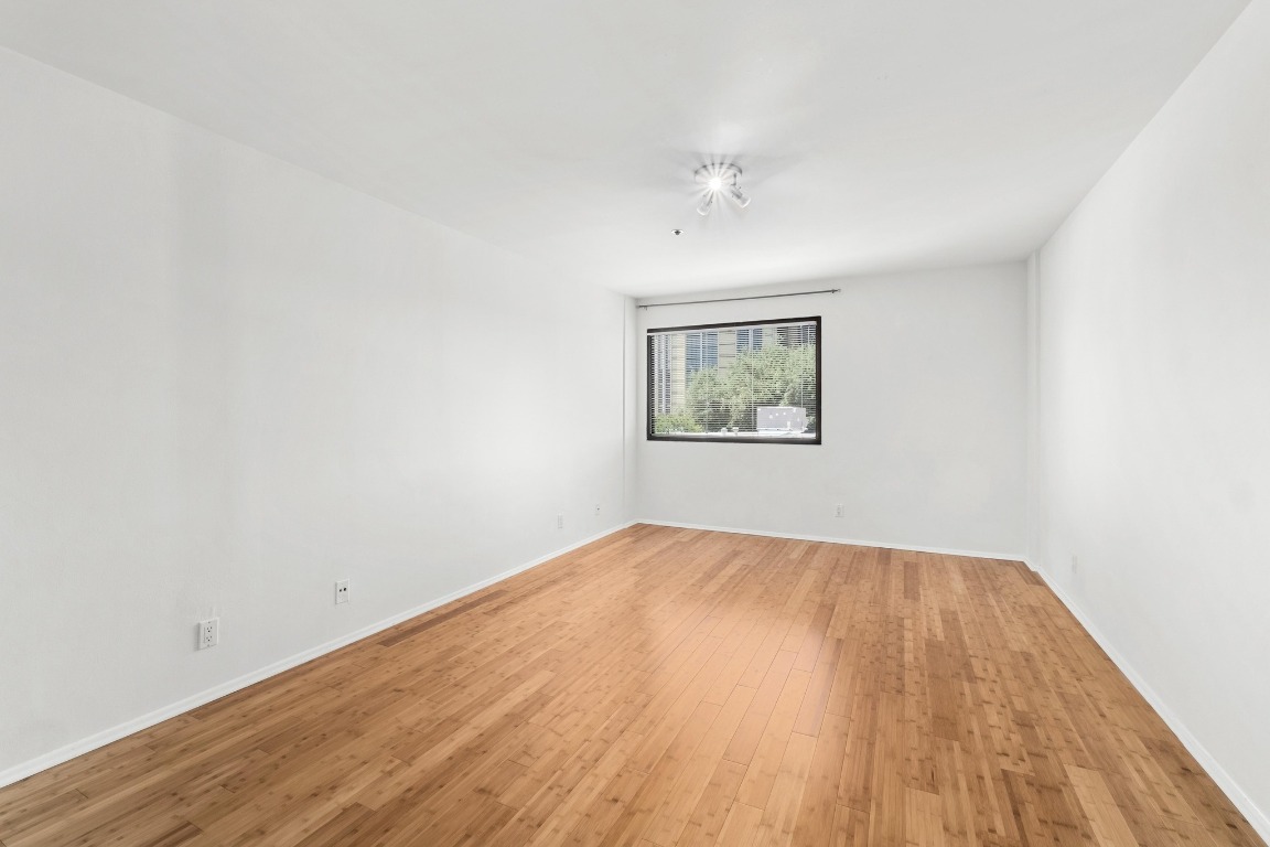 40 North Interstate Highway 35, Unit 3D3 Austin, TX 78701 - Photo 14 of 40 an empty room with wooden floor and windows