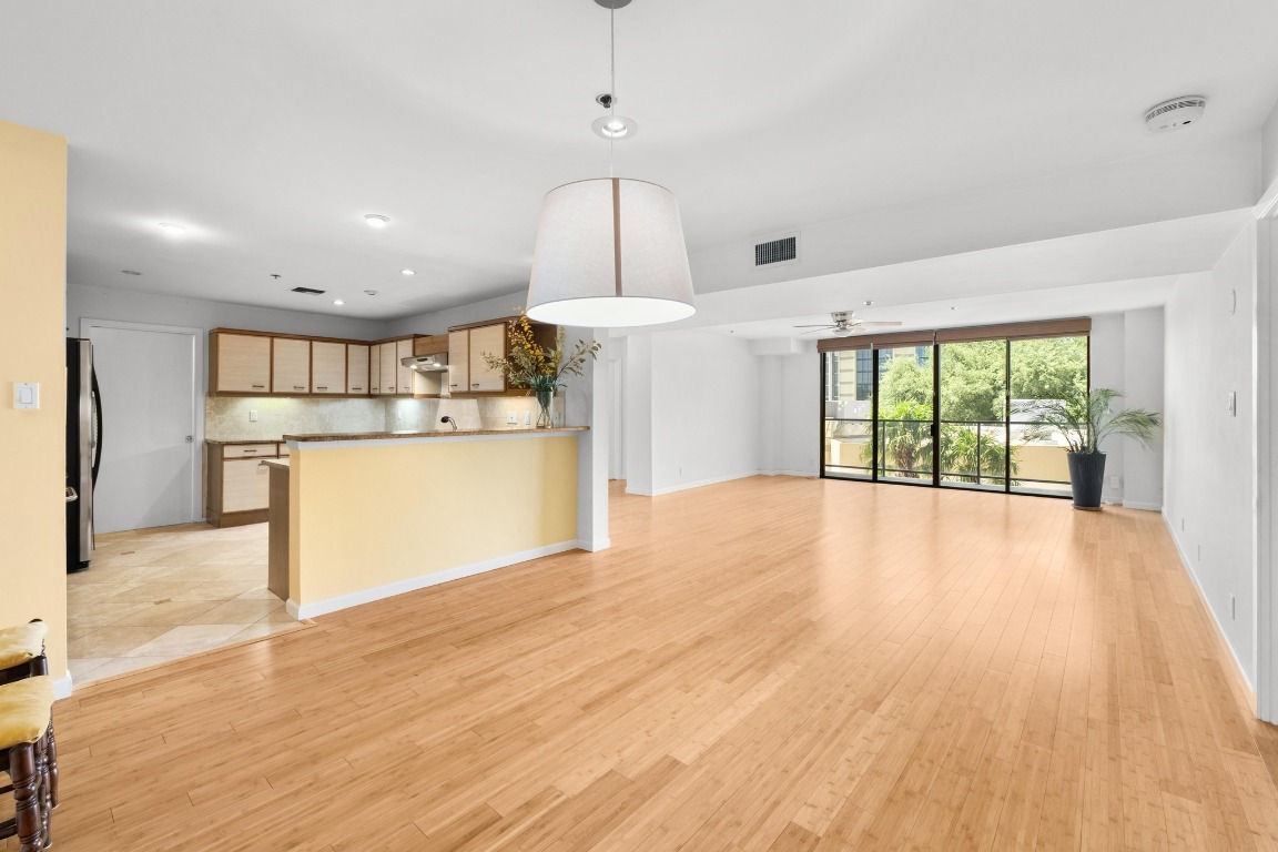 40 North Interstate Highway 35, Unit 3D3 Austin, TX 78701 - Photo 7 of 40 a view of a kitchen with refrigerator and wooden floor