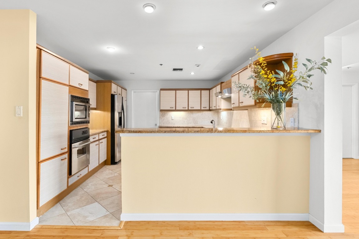 40 North Interstate Highway 35, Unit 3D3 Austin, TX 78701 - Photo 8 of 40 a view of kitchen with stainless steel appliances granite countertop cabinets and a rug