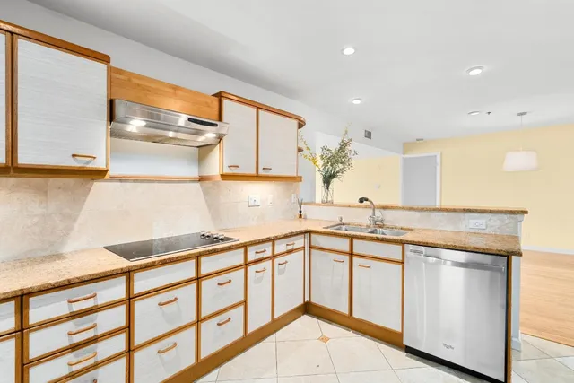 a kitchen with stainless steel appliances granite countertop a sink and cabinets