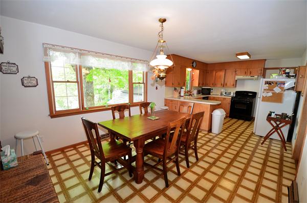 996 Reservoir Road Otis, MA 01253 - Photo 12 of 24 a view of a dining room with furniture and a chandelier