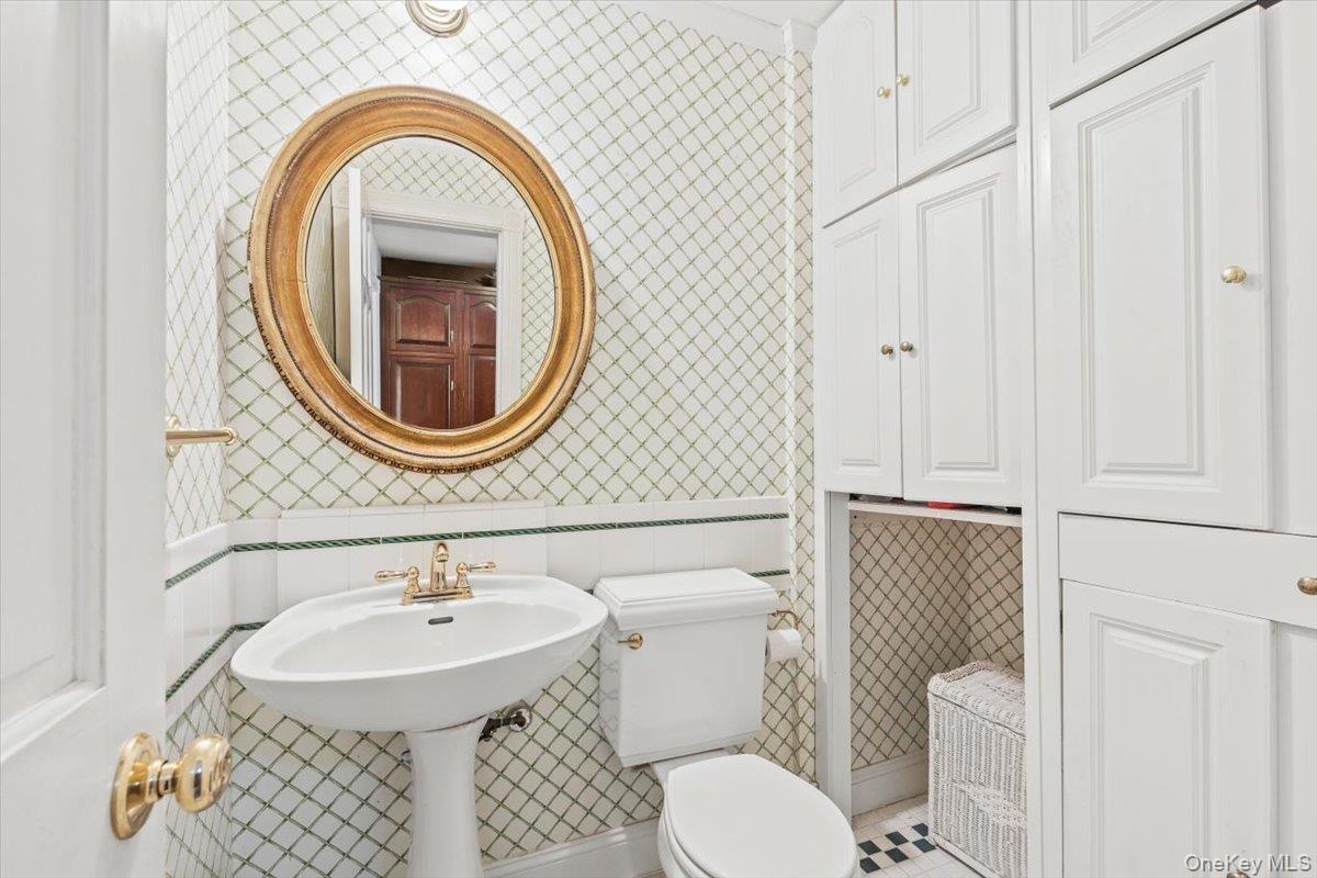 655 North Street Harrison, NY 10580 - Photo 14 of 48 a bathroom with a sink a toilet and a mirror